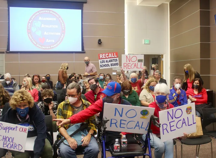 Supporters and opponents of an effort to recall members of the Los Alamitos Unified School District Board of Education attend
