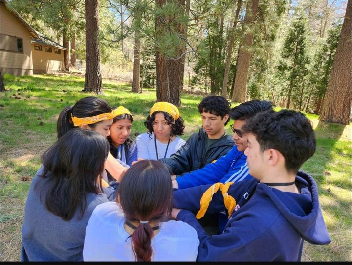 The author plays the “human knot” game with her team during the Rotary Youth Leadership Awards camp at Idyllwild Pines last m
