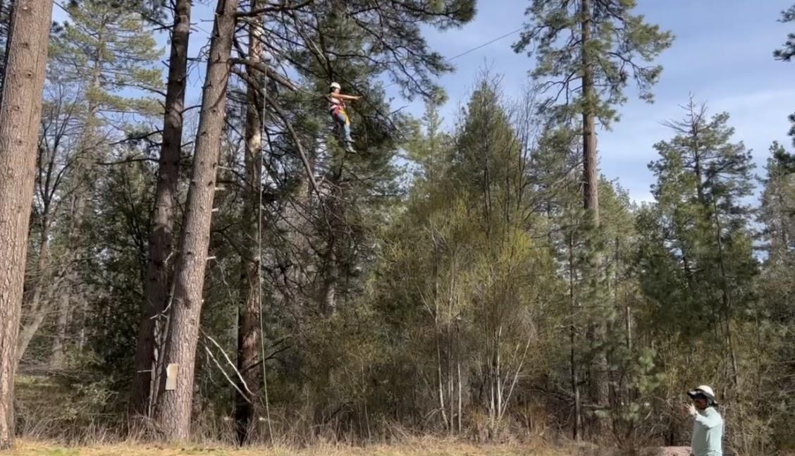 An Idyllwild staff member directs the author as her team pulls her up on the giant swing. Photo by Alle Peak.