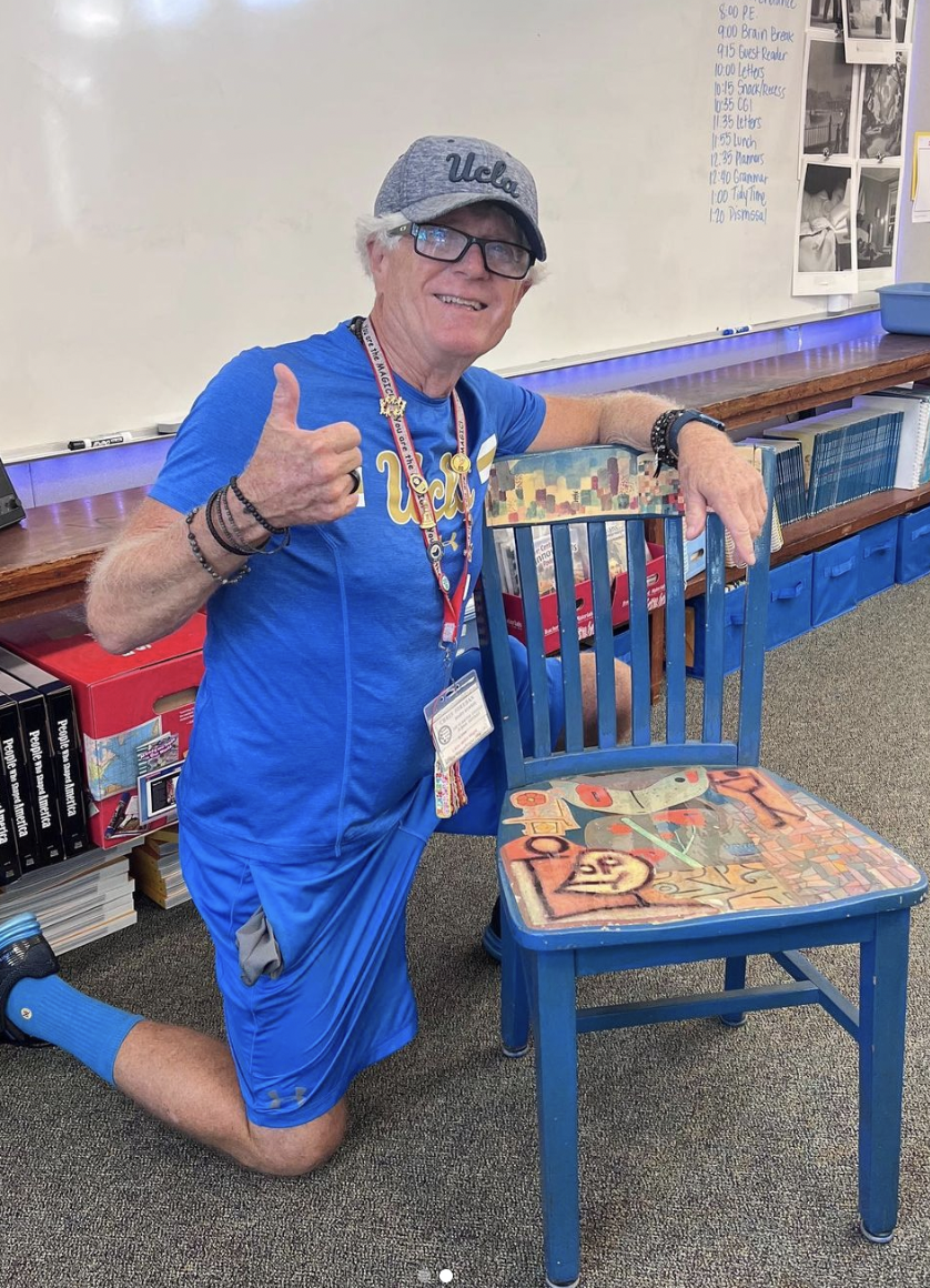 In Breedlove's classroom at McGaugh, Forehan poses with the chair he created for her late father, educator Rob Williams. Courtesy photo.