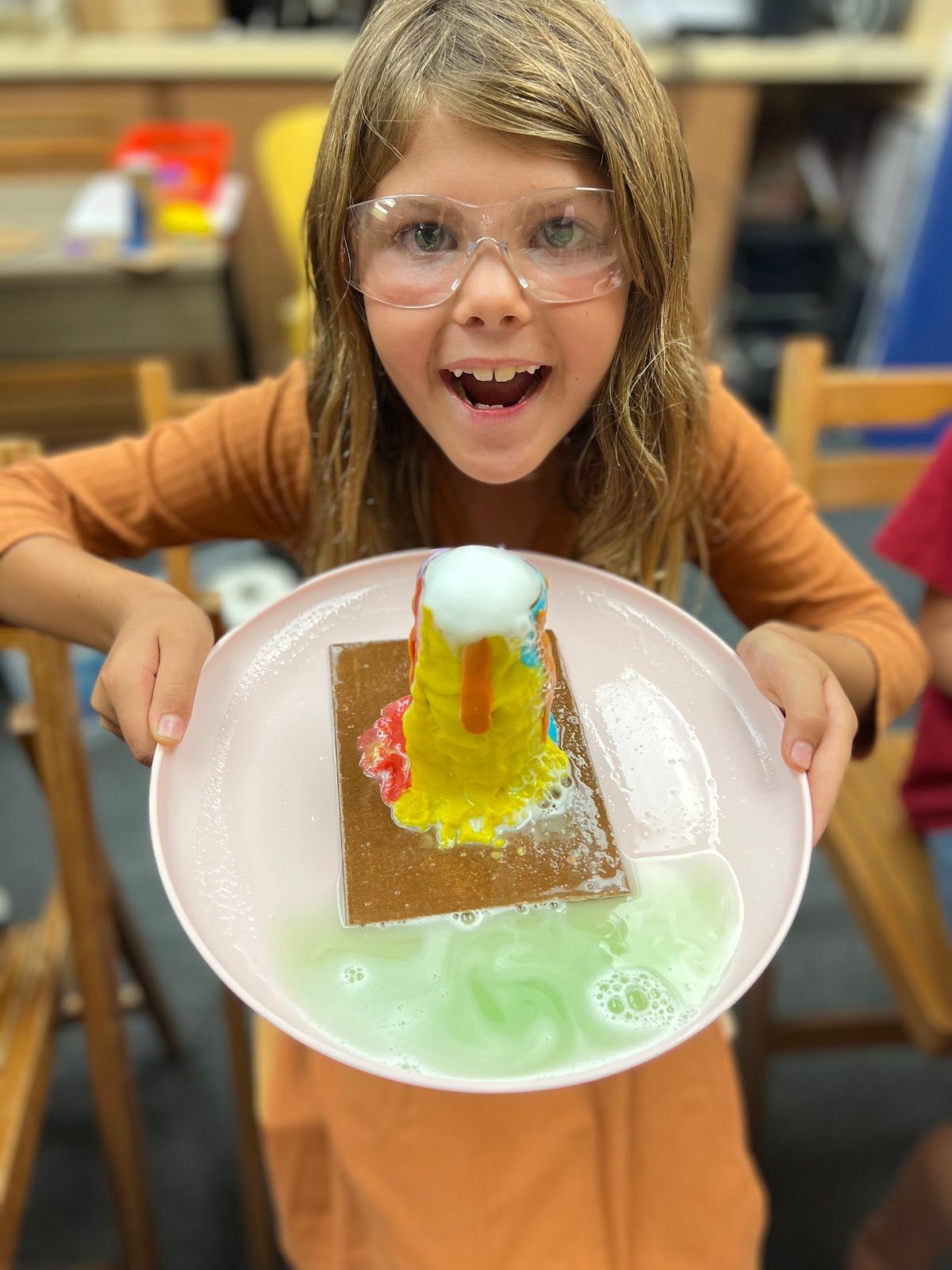 One of Saadeh’s students holds up her successfully erupted volcano. Photo by Sarah Saadeh.