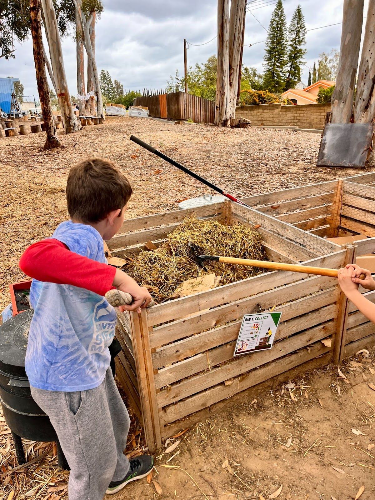 Students at Santiago STEAM Magnet tend to one of three composting stations located on campus. Photo by Jeannette Andruss.