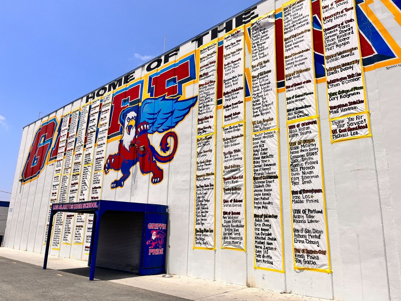 The exterior of the gymnasium at Los Alamitos High School displays posters showing where students from the Class of 2023 are headed after graduation. (Photo by Jeannette Andruss.)