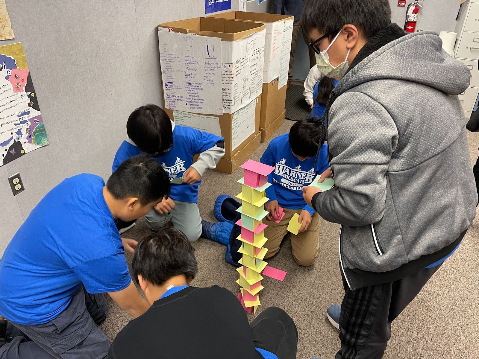 Warner Middle School students take part in a team-building exercise where kids have to build a tower using index cards but they cannot speak during the construction. Photo courtesy of Westminster School District.