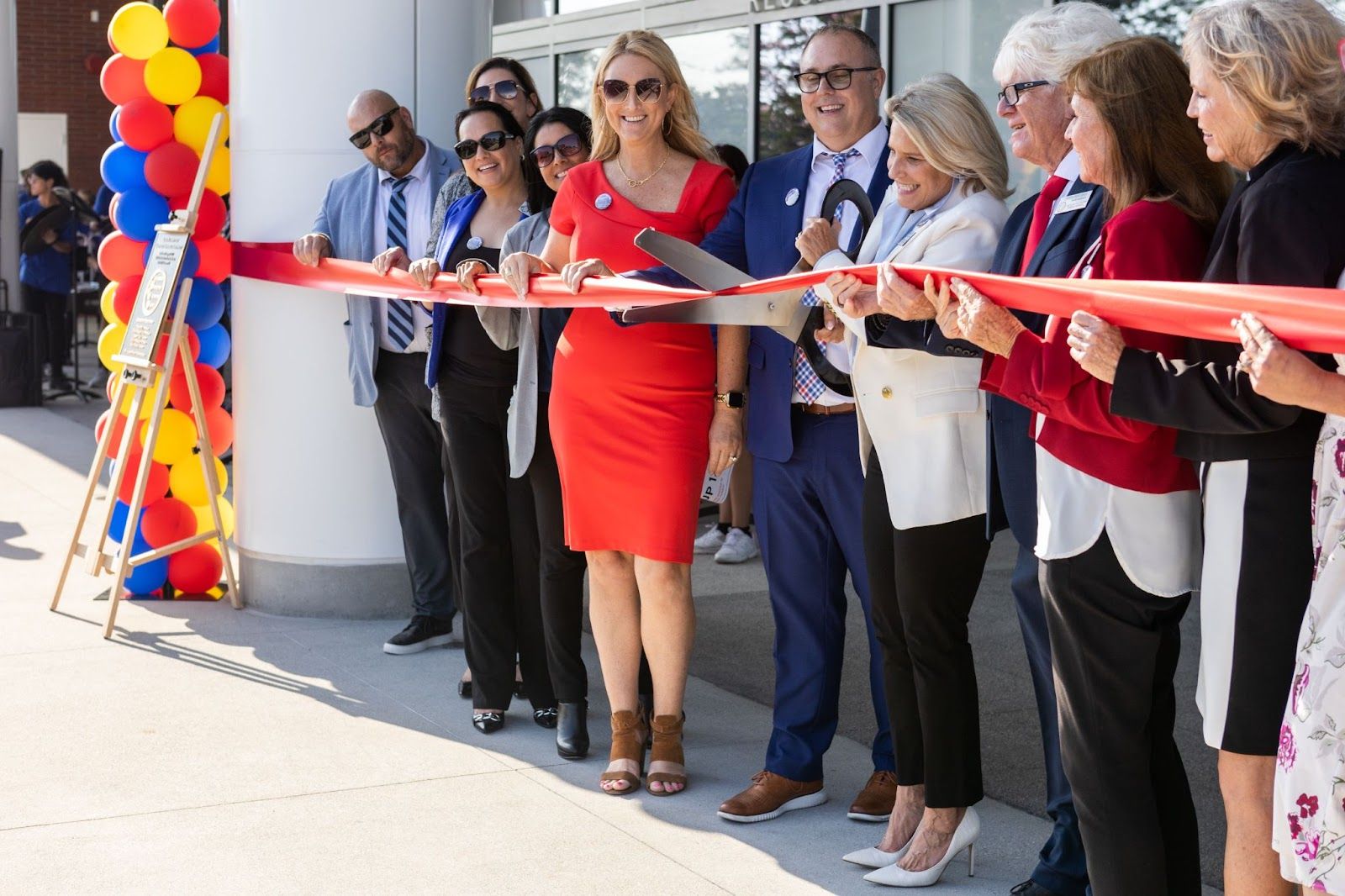 Los Al USD Board of Education President Diana Hill cuts the ribbon at a ceremony marking the opening of the new STEM building at LAHS. On her right is Supt. Andrew Pulver and to his right is Deputy Supt. Ondrea Reed along with other district administrators. To Hill's left is Board Vice President Chris Forehan, board member Megan Cutuli and board member Marlys Davidson. Photo by Andrew Ficke.