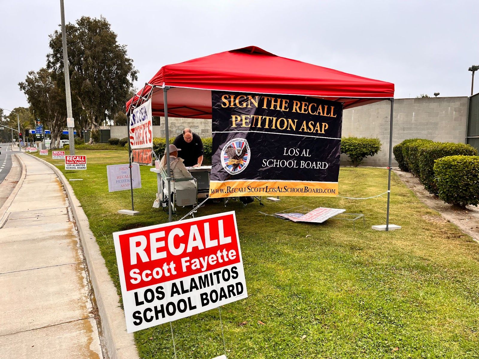 Supporters of an effort to recall Scott Fayette gather signatures last month on Lampson Avenue in Seal Beach. Photo by Jeannette Andruss.