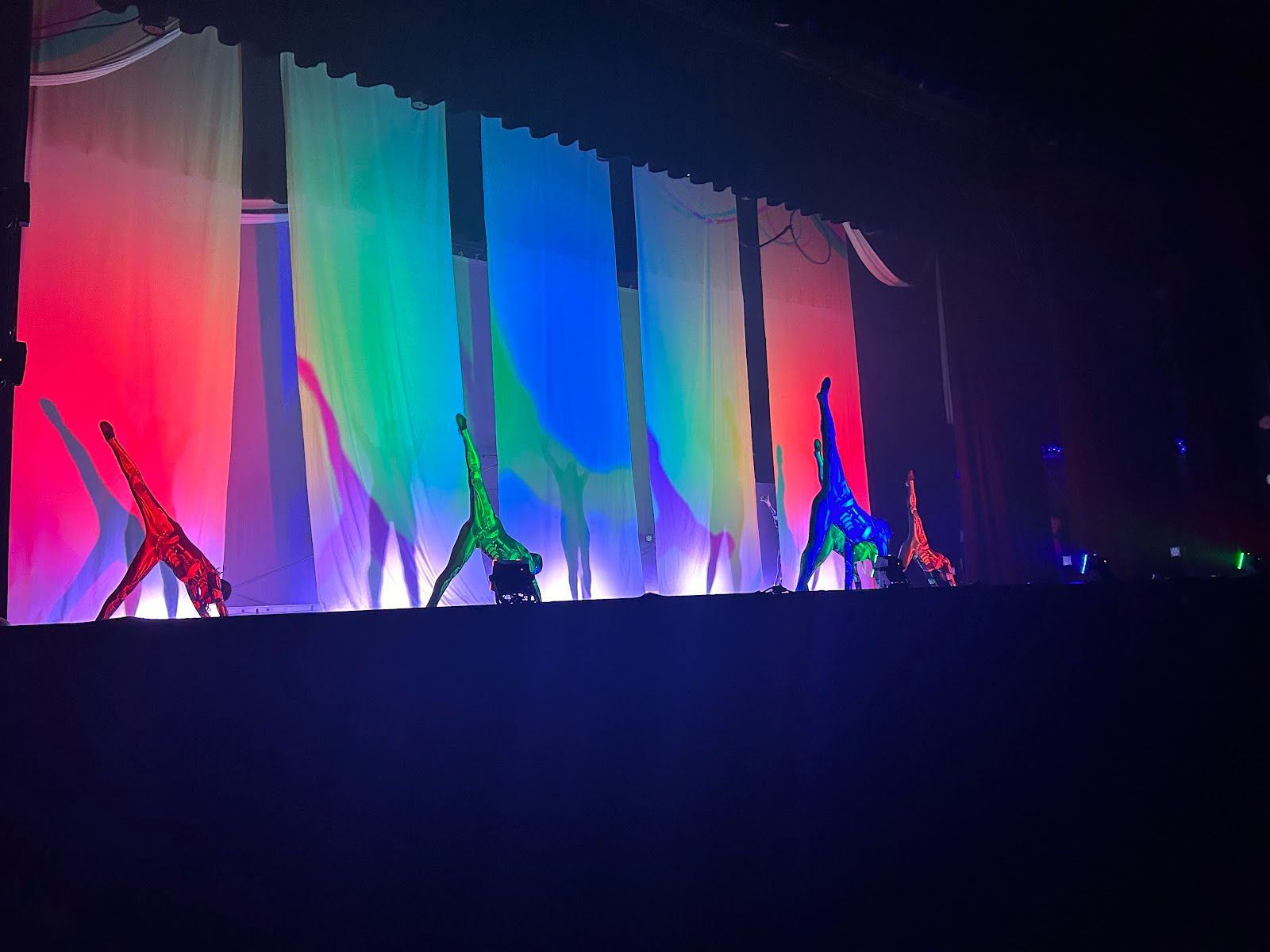 White sheets create shadows of the dancers playing the Collective robots in “Inside.” Photo by Bella Kim