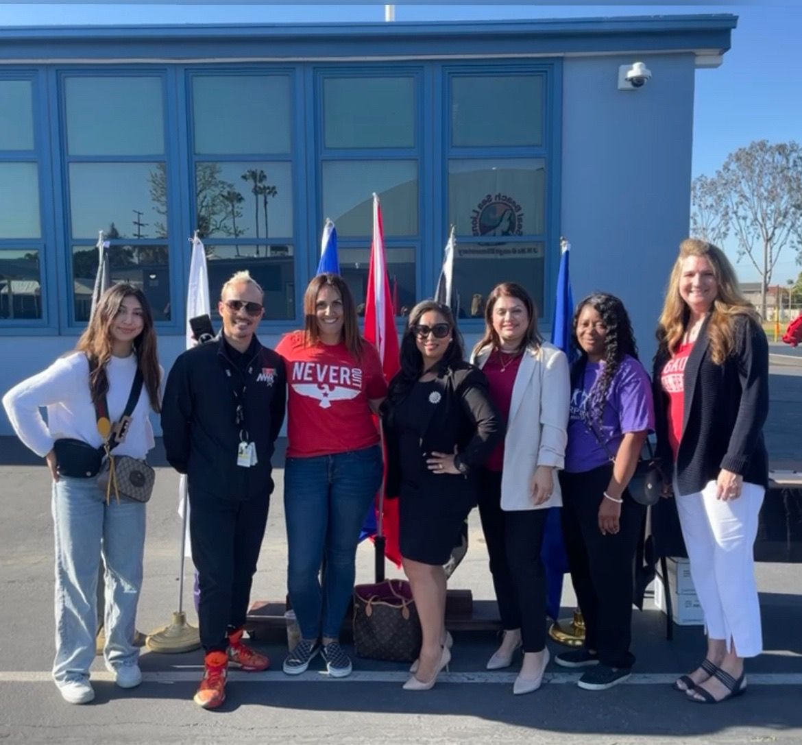 Brandi Jones, in the black suit and sunglasses, is a military spouse who founded McGaugh's "Week of the Military Child" when her children attended the school in Seal Beach more than ten years ago. Jones returned on April 21 to take part in a ceremony honoring military families. Next to Jones in the red t-shirt is Cynthia Villa, the McGaugh parent who headed up the event this year. Also pictured is McGaugh Principal Wendy Wood, far right. Photo courtesy of Brandi Jones.