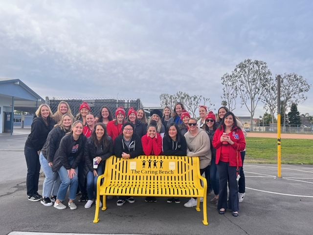 McGaugh Elementary School teachers and staff pictured around the bench a campus committee commissioned to memorialize their former colleague, teacher Cari Crevda McQuiston. Courtesy photo.