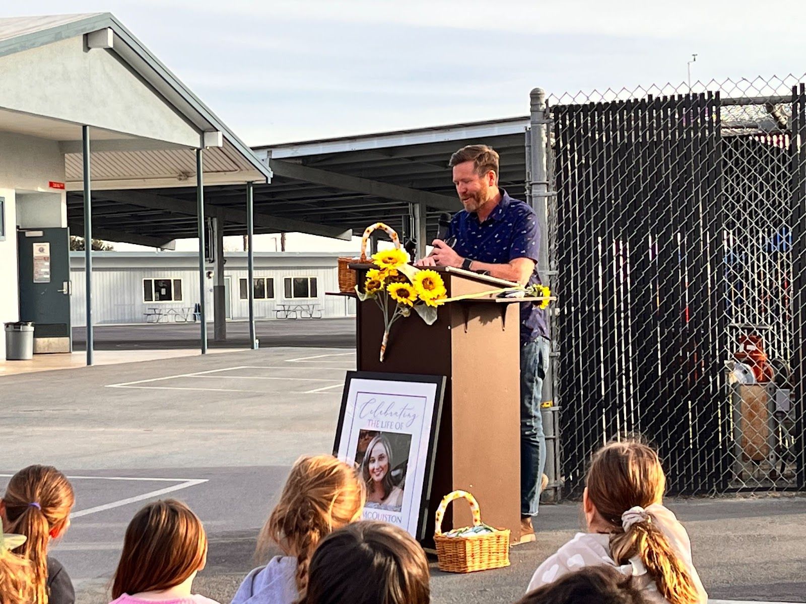 Brandon McQuiston speaks about his late wife during a bench dedication ceremony honoring the former McGaugh teacher on Feb. 16, 2023. He thanked the campus community for supporting his family. 'I want you all to know how much we appreciate all that you've done to carry us through this very difficult time.' Photo by Jeannette Andruss.